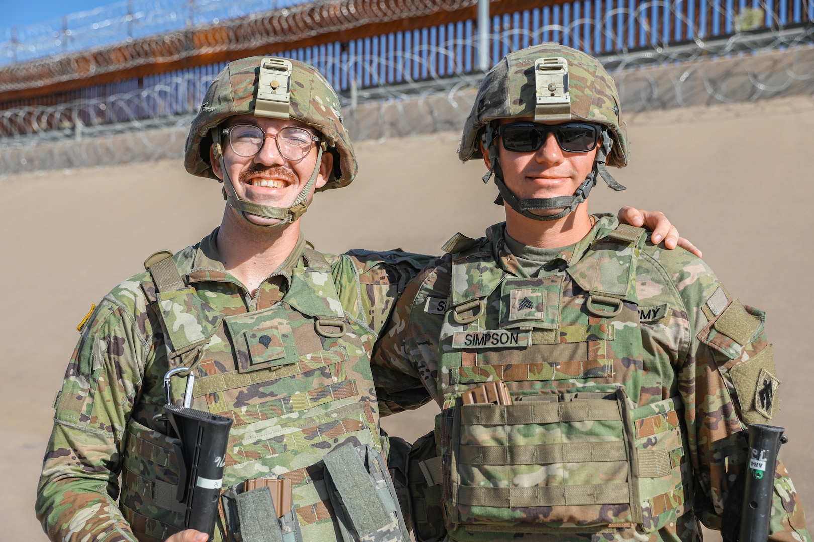 Spc. Darrell Casey and Sgt. Sean Simpson, both McLoud, Oklahoma High School graduates serving as cannon crewmembers with the 1st Battalion, 160th Field Artillery Regiment, 45th Infantry Brigade Combat Team, pose for a photo together while on patrol along the US-Mexico border on Aug. 4, 2023. The two friends are part of the Oklahoma National Guard task force deployed to the border in support of the Texas Military Department's Operation Lonestar. (Oklahoma National Guard photo by Sgt. Reece Heck)