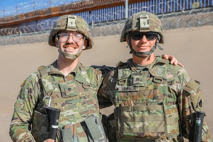 Spc. Darrell Casey and Sgt. Sean Simpson, both McLoud, Oklahoma High School graduates serving as cannon crewmembers with the 1st Battalion, 160th Field Artillery Regiment, 45th Infantry Brigade Combat Team, pose for a photo together while on patrol along the US-Mexico border on Aug. 4, 2023. The two friends are part of the Oklahoma National Guard task force deployed to the border in support of the Texas Military Department's Operation Lonestar. (Oklahoma National Guard photo by Sgt. Reece Heck)