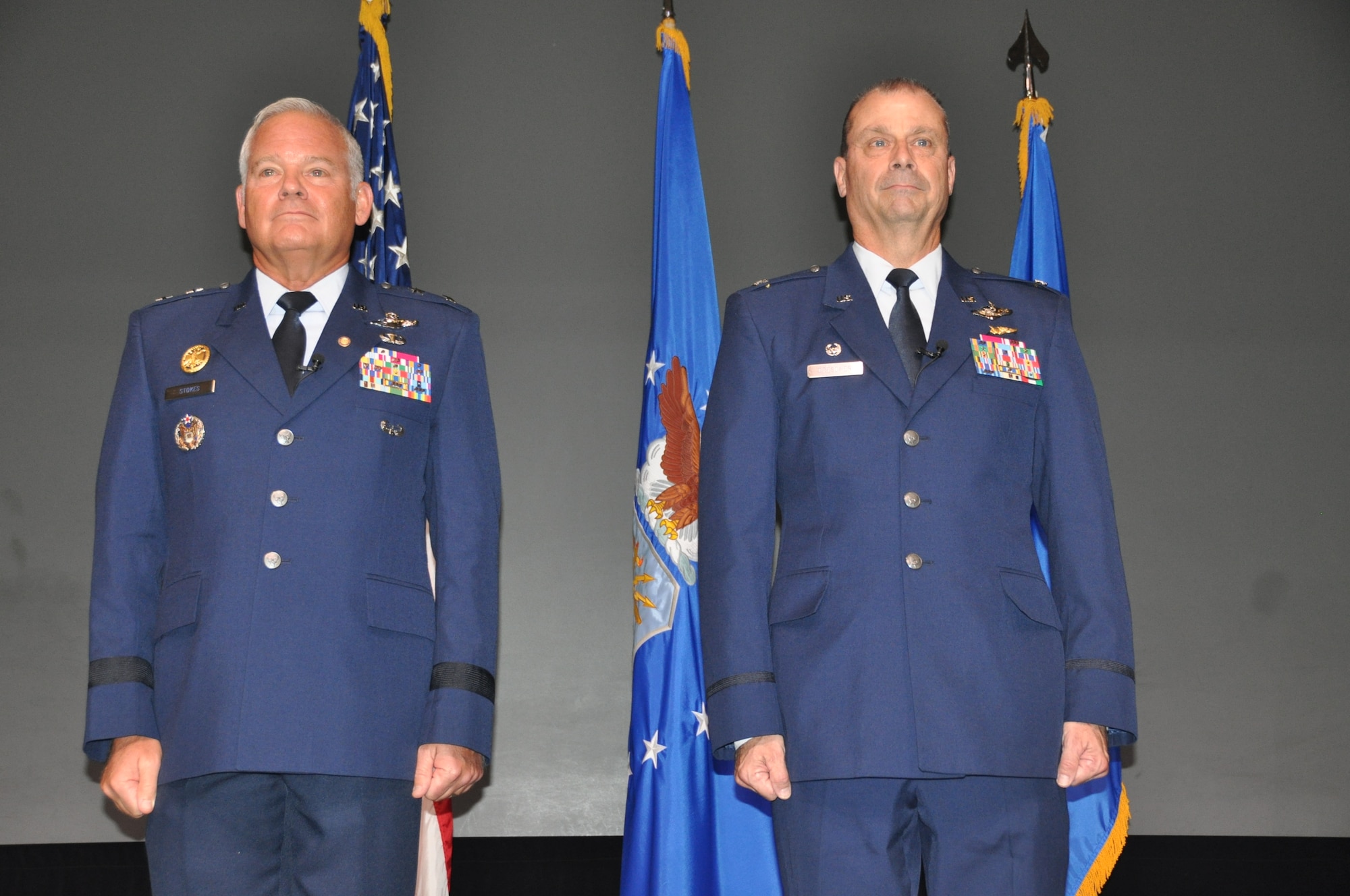 two men stand at attention during a ceremony