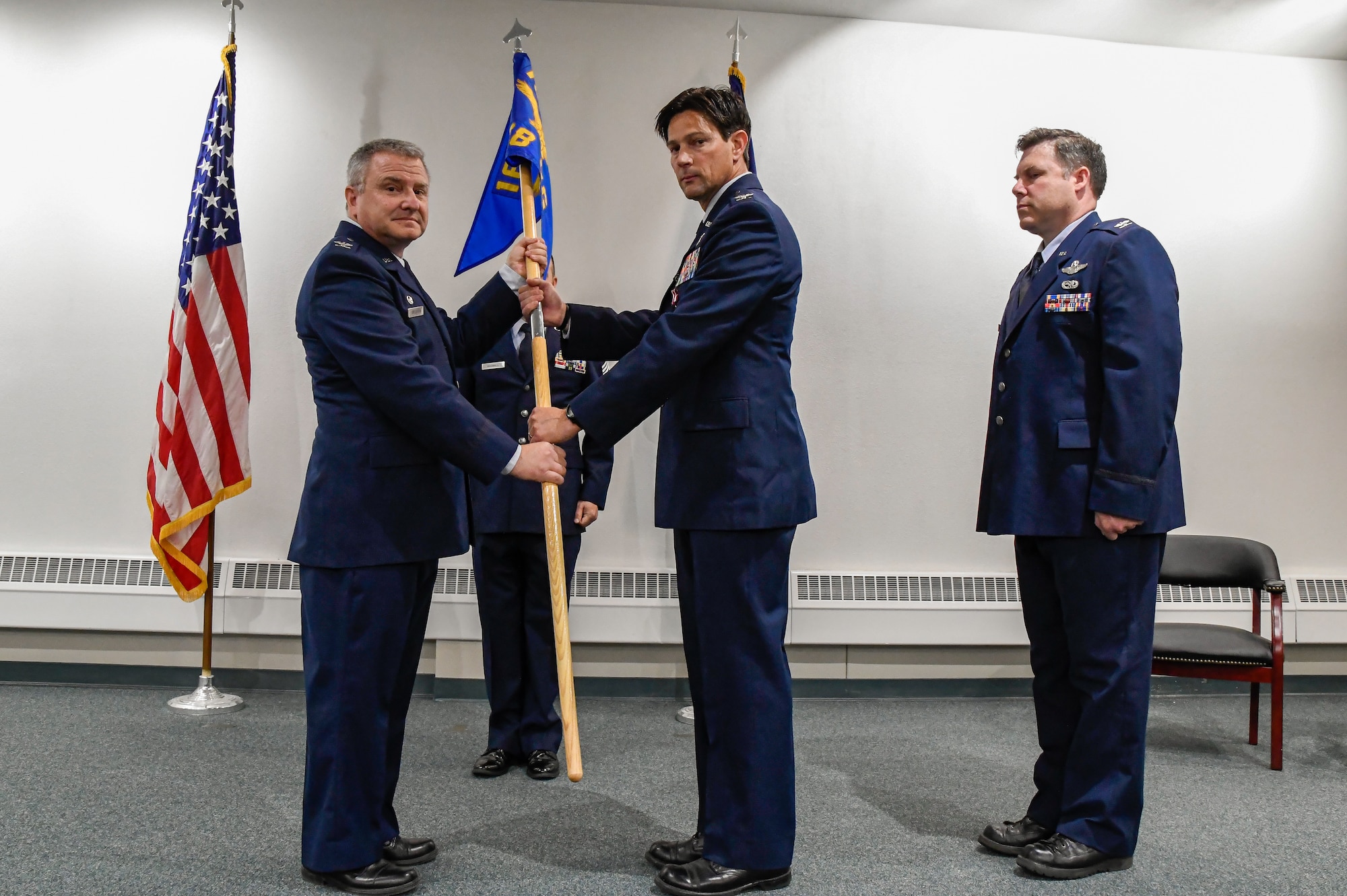 Col. Michael Griesbaum, 168th Wing commander transfers the guidon to Col. Ronald Oliver, 168th Wing Deputy commander during a change of command ceremony August 5, 2023, at Eielson Air Force Base, Alaska. A Change of command ceremony is a military tradition representing the formal transfer of responsibility of a unit from one commanding officer to another. (U.S. Air National Guard photo by Senior Master Sgt. Julie Avey)