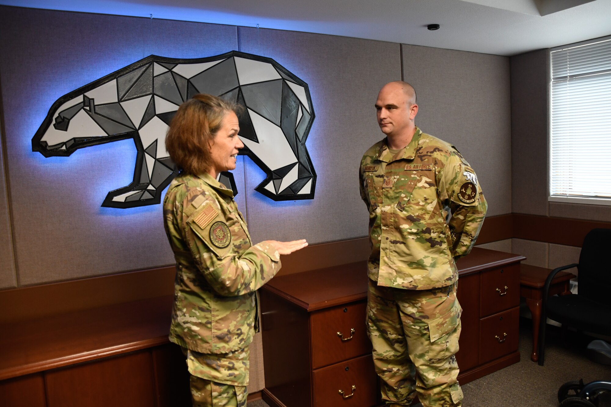 Maj. Gen. Laurie M. Farris, Air National Guard Assistant to the commander, Air Mobility Command, coins Master Sgt. Brent Garrison of the 168th Medical Group at Eielson Air Force Base, Alaska, August 22, 2023. Farris met with leadership from various organizations, and most of Farris' visit was spent talking with Guardsmen and recognizing their service. (U.S. Air National Guard photo by Senior Master Sgt. Julie Avey)