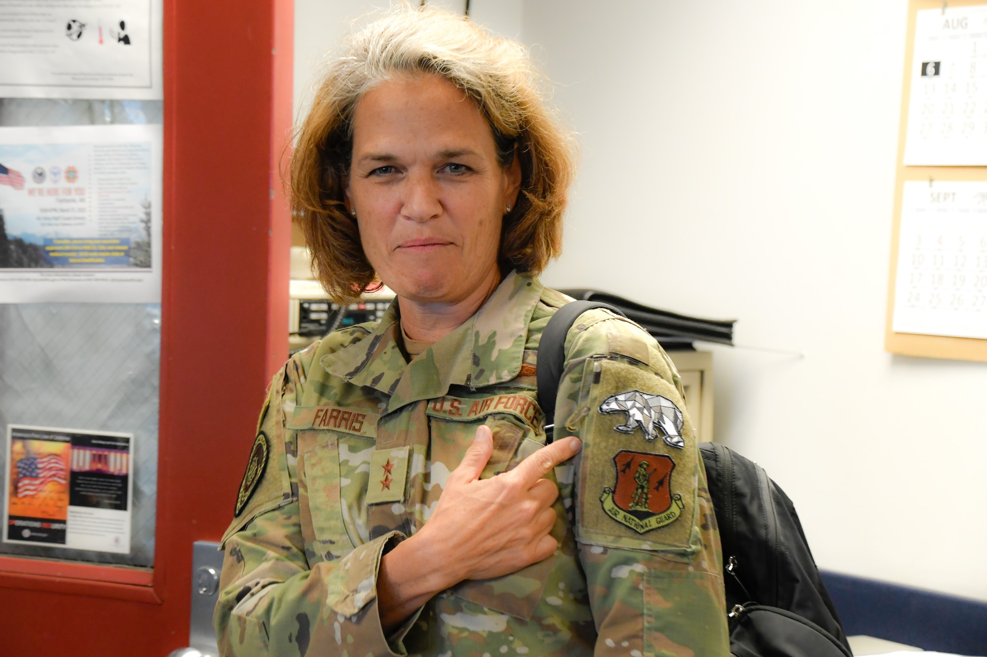 Maj. Gen. Laurie M. Farris, Air National Guard Assistant to the commander, Air Mobility Command, talks with members of the 168th Maintenance Group, expressing how proud she is of their dedication and hard work in the Arctic as she points to the polar bear patch she is wearing as a distinguished visitor of the wing, Eielson Air Force Base, Alaska, August 22, 2023. Farris met with leadership from various organizations, and most of Farris' visit was spent talking with Guardsmen and recognizing their service. (U.S. Air National Guard photo by Senior Master Sgt. Julie Avey)
