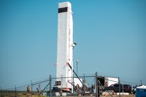 Airmen from the 91st Missile Maintenance Squadron raise a transport erector to its full height at Minot Air Force Base, North Dakota, July 10, 2023. The Airmen used the transport erector to lower an intercontinental ballistic missile III into a missile silo as part of Operation Bullystick. (U.S. Air Force photo by Airman 1st Class Trust Tate)
