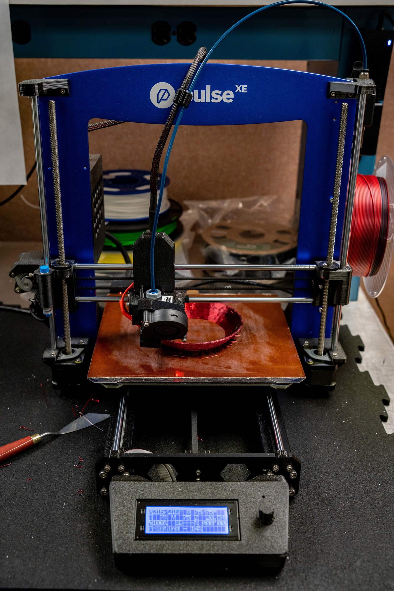 A 3D printer creating a piece of a jet engine model.