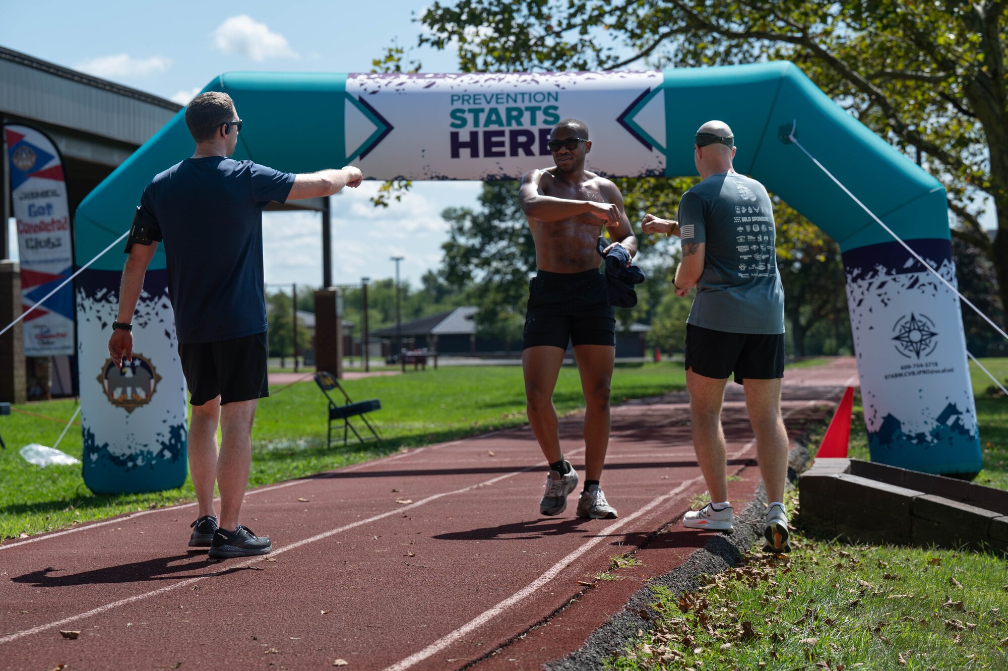 Man shares a fist bump at finish line