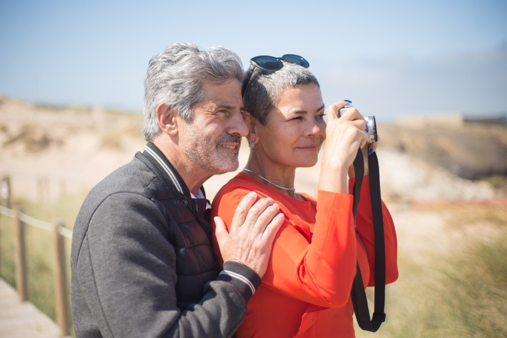 Man and woman use a camera outdoors