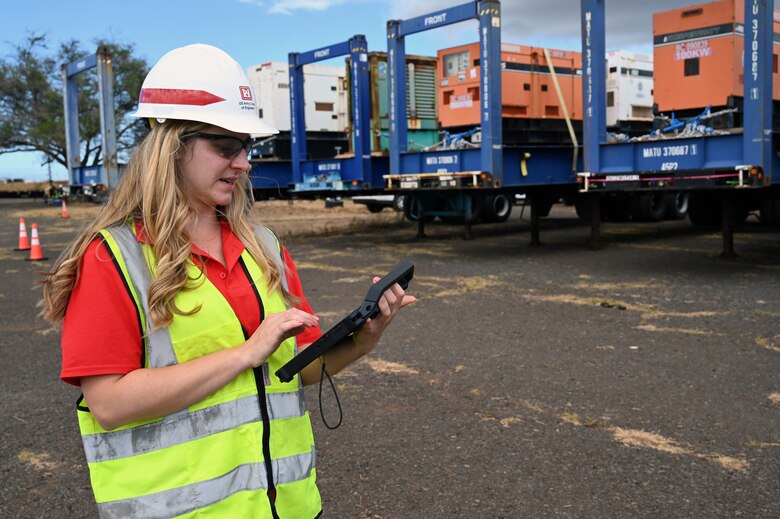 Jennifer Kist, U.S. Army Corps of Engineers, Charleston District geographer currently deployed to support recovery Hawai'i Wildfire recovery efforts as a geographer, tracks generators with a tablet at a temporary work site in Kahului, Hawai’i, Aug. 25. The USACE temporary power team is providing critical emergency power to critical infrastructure impacted by the wildfires Aug. 8. USACE also deployed Soldiers from the 249th Prime Power Engineer Battalion to support the recovery efforts.