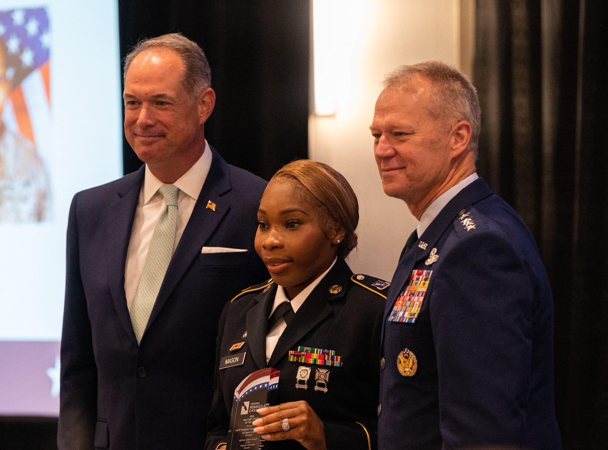 Mason poses for a photo with Gen Kelly and Dominion Energy representative
