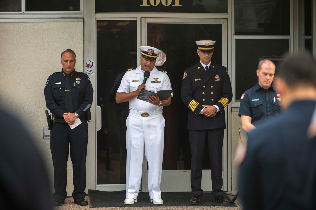 CORONADO, Calif. (Sept. 11, 2023) Lt. Cmdr. Aman Grant, center, command chaplain at Naval Special Warfare Group 1, delivers the invocation during a 9/11 remembrance ceremony at the Coronado Fire Department Headquarters. Naval Special Warfare is the nation's elite maritime special operations force, uniquely positioned to extend the Fleet's reach and gain and maintain access for the Joint Force in competition and conflict.