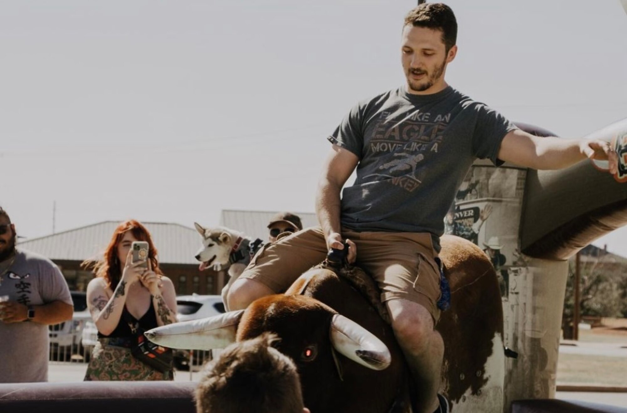 Members from Dyess Air Force Base, Texas, ride a mechanical bull