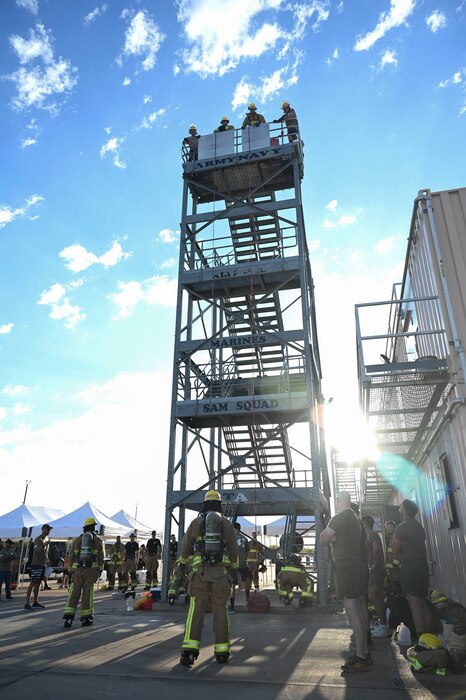 Members assigned to the 312th Training Squadron prepare to compete in a combat challenge during the Blood, Sweat and Stairs event at the Louis F. Garland Department of Defense Fire Academy, Goodfellow Air Force Base, Texas, Sept. 9, 2023. The combat challenge consisted of challenges that simulated different challenges firefighters faced while responding to the 9/11 terrorist attacks. (U.S. Air Force photo by Airman 1st Class Madison Collier)