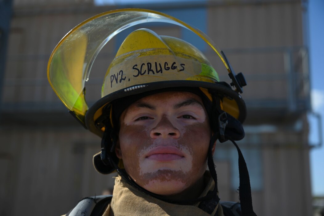 U.S. Army Pvt. 2nd Class Caden Scruggs, 312th Training Squadron student, poses for a photo after he completed the final race of the combat challenge during the Blood, Sweat and Stairs event at the Louis F. Garland Department of Defense Fire Academy, Goodfellow Air Force Base, Texas, Sept. 9, 2023. Scruggs competed on the Army Wolf Pups team against the U.S. Air Force War Hammers team for the championship title. Students and instructors faced off in timed endurance and strength challenges through multiple rounds competing as teams of five throughout the day; these challenges simulated different abilities firefighters must have when participating in rescue operations such as the 9/11 terrorist attacks. (U.S. Air Force photo by Airman 1st Class Madison Collier)