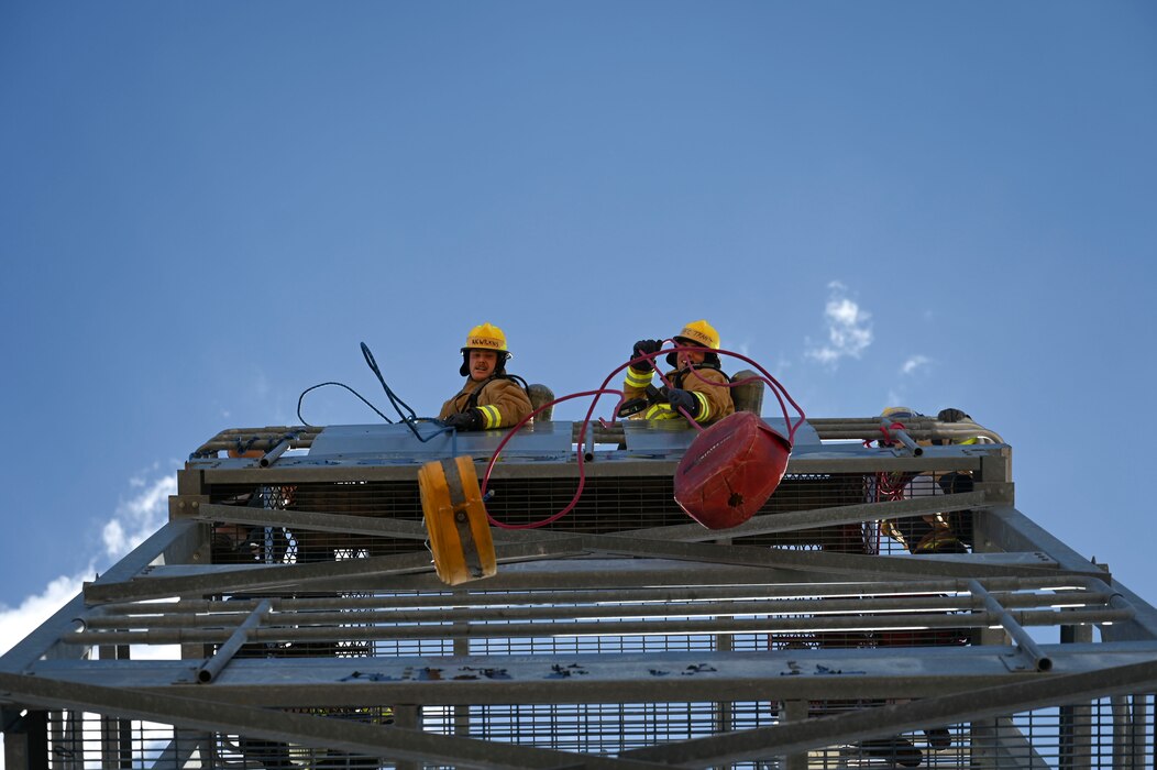 Members of the U.S. Air Force Wolf Pups team (right) celebrate their victory over the U.S. Army War Hammers team (left) after the final round of the combat challenge during the 11th Annual Blood, Sweat and Stairs event at the Louis F. Garland Department of Defense Fire Academy, Goodfellow Air Force Base, Texas, Sept. 9, 2023. Students and instructors faced off in timed endurance and strength challenges through multiple rounds competing as teams of five throughout the day; these challenges simulated different abilities firefighters must have when participating in rescue operations such as the 9/11 terrorist attacks. (U.S. Air Force photo by Airman 1st Class Madison Collier)