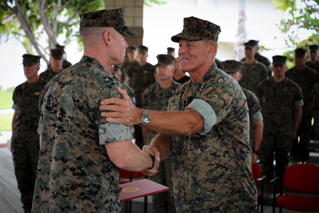 U.S. Marine Corps Colonel Samuel L. Meyer (left), outgoing Commanding Officer of the 13th Marine Expeditionary Unit, is awarded the Legion of Merit by Lieutenant General George W. Smith Jr., I Marine Expeditionary Force Commanding General, during the 13th MEU Change of Command Ceremony at Marine Corps Base Camp Pendleton, California, Aug. 10, 2023. Colonel Samuel L. Meyer relinquished command of the 13th MEU to Colonel Stuart W. Glenn. A Change of Command Ceremony is a time-honored tradition that demonstrates passing of authority and responsibilities from one commanding officer to another. (U.S. Marine Corps photo by Cpl. Quince D. Bisard)