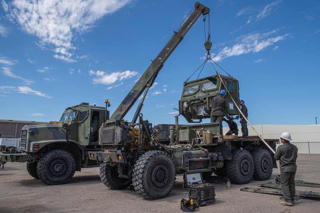 U.S. Marine Corps motor transportation Marines assigned to Combat Logistics Battalion 15, 15th Marine Expeditionary Unit, hoist the cab of a Medium Tactical Vehicle Replacement truck with an AMK36 wrecker vehicle during Realistic Urban Training exercise at Marine Corps Air Station Yuma, Arizona, Aug. 14, 2023. RUT is a shore-based, MEU-level exercise that provides an opportunity to train and execute operations as a Marine Air-Ground Task Force in urban environments. (U.S. Marine Corps photo by Cpl. Amelia Kang)