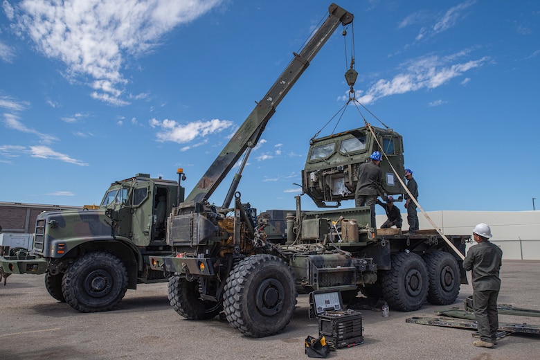 U.S. Marine Corps motor transportation Marines assigned to Combat Logistics Battalion 15, 15th Marine Expeditionary Unit, hoist the cab of a Medium Tactical Vehicle Replacement truck with an AMK36 wrecker vehicle during Realistic Urban Training exercise at Marine Corps Air Station Yuma, Arizona, Aug. 14, 2023. RUT is a shore-based, MEU-level exercise that provides an opportunity to train and execute operations as a Marine Air-Ground Task Force in urban environments.