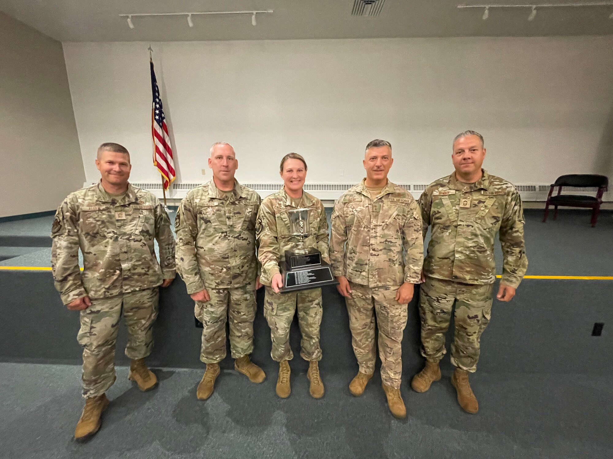 From left, Chief Master Sgt. Ray Allen, Chief Master Sgt. Phillip Newton, Col. Jennifer Casillo, Maj. Gen. Torrence Saxe and Chief Master Sgt. George Bender pose for a photo with the Alaska Governor’s Trophy