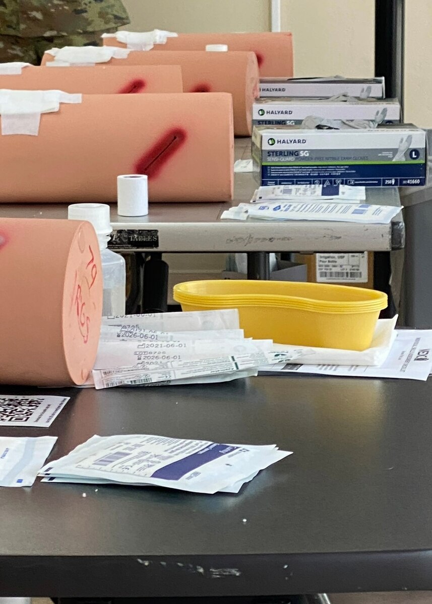 A photo of training limbs on tables with bandages.