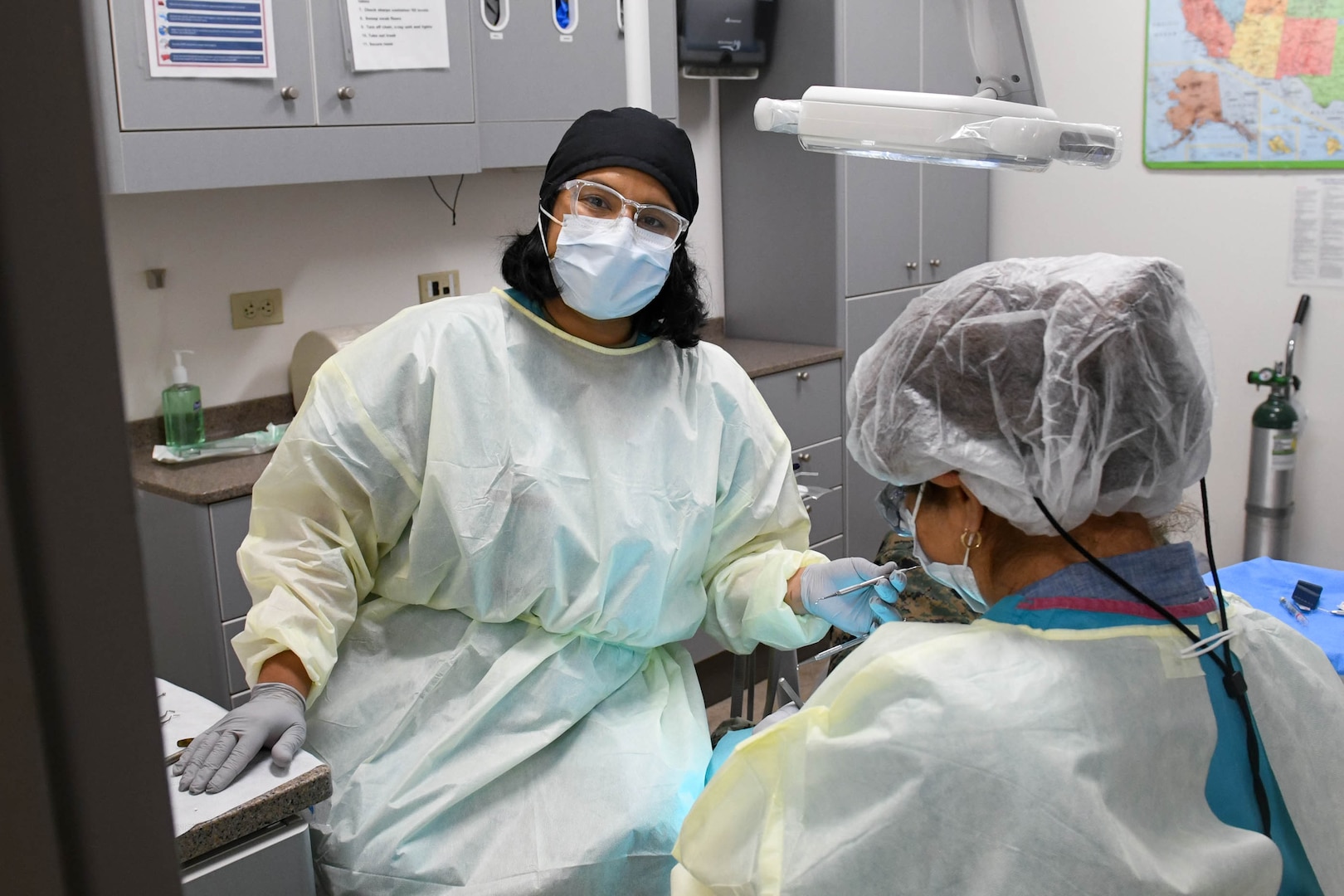 Two members in scrubs in dental office