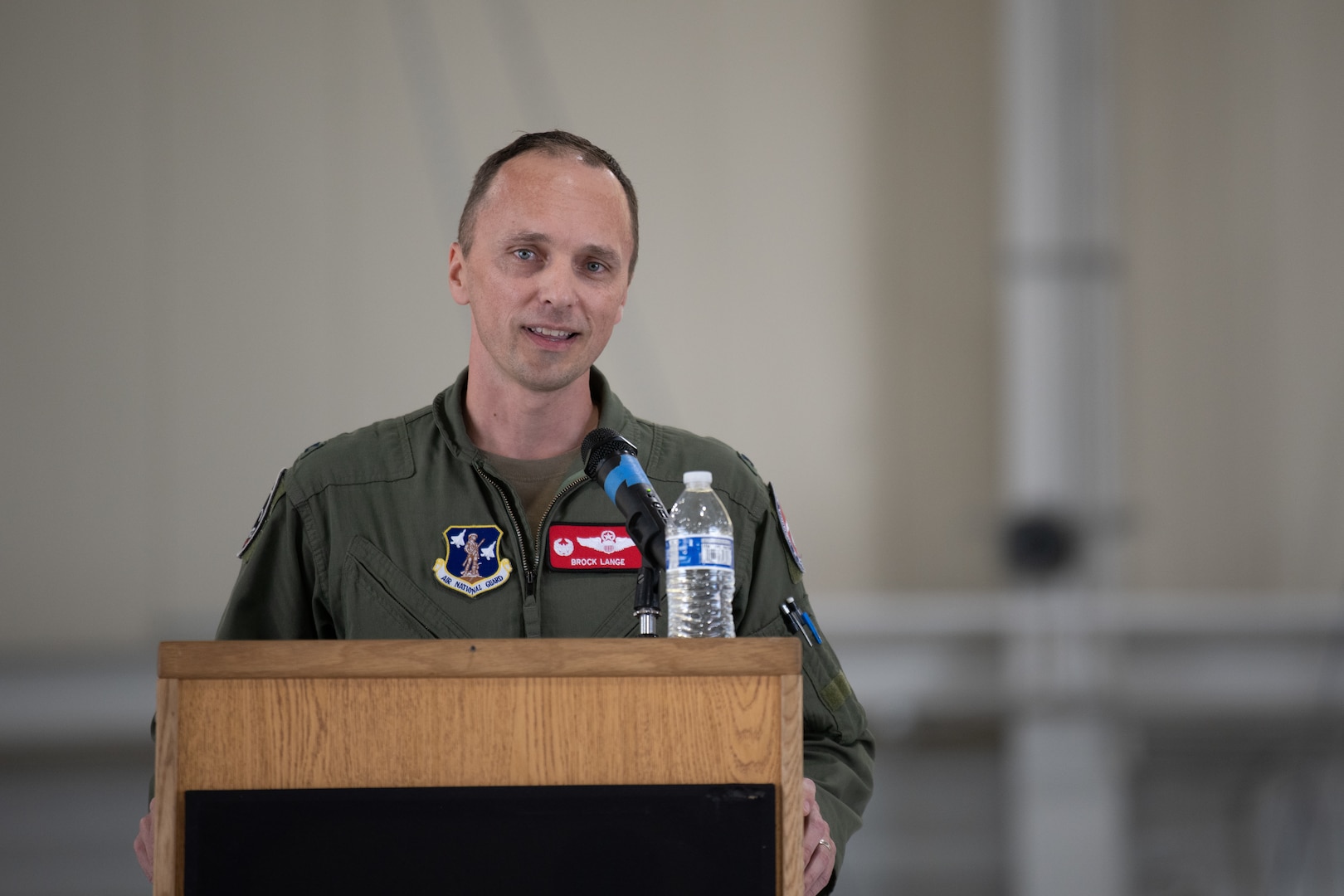 Col. Lange stands at podium