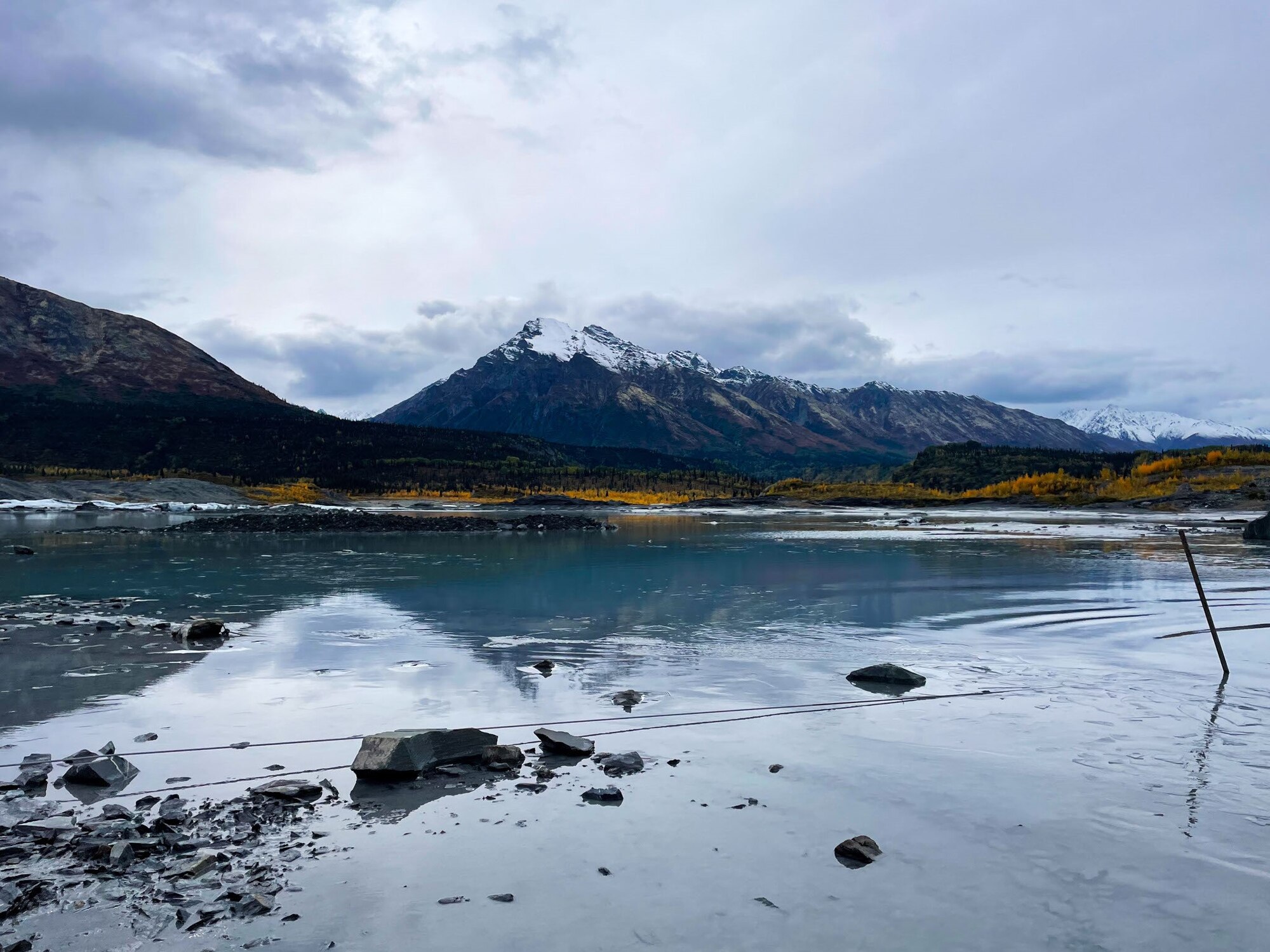 mountain rises above glassy lake