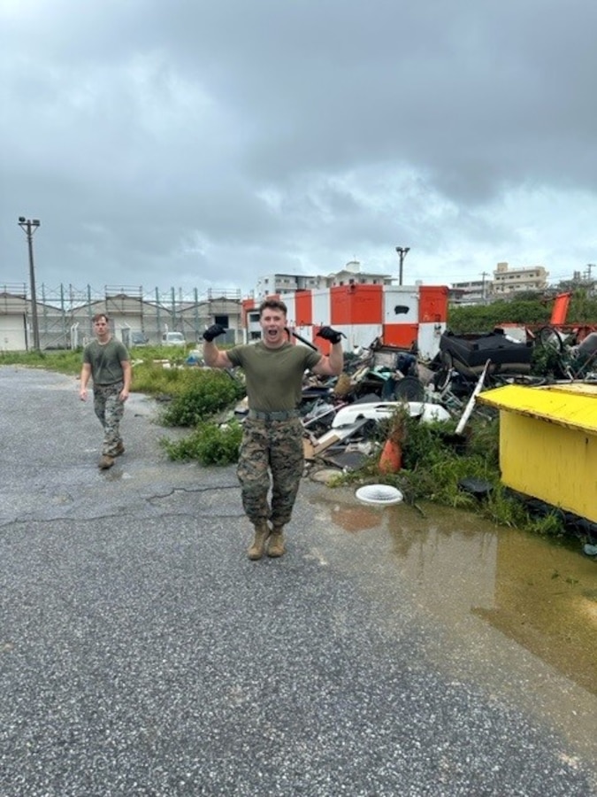 Marines from MCAS Futenma Air Traffic Control section conduct airfield clean-up operations following Typhoon KHANUN where wind speeds exceeded 100 mph for multiple days.
