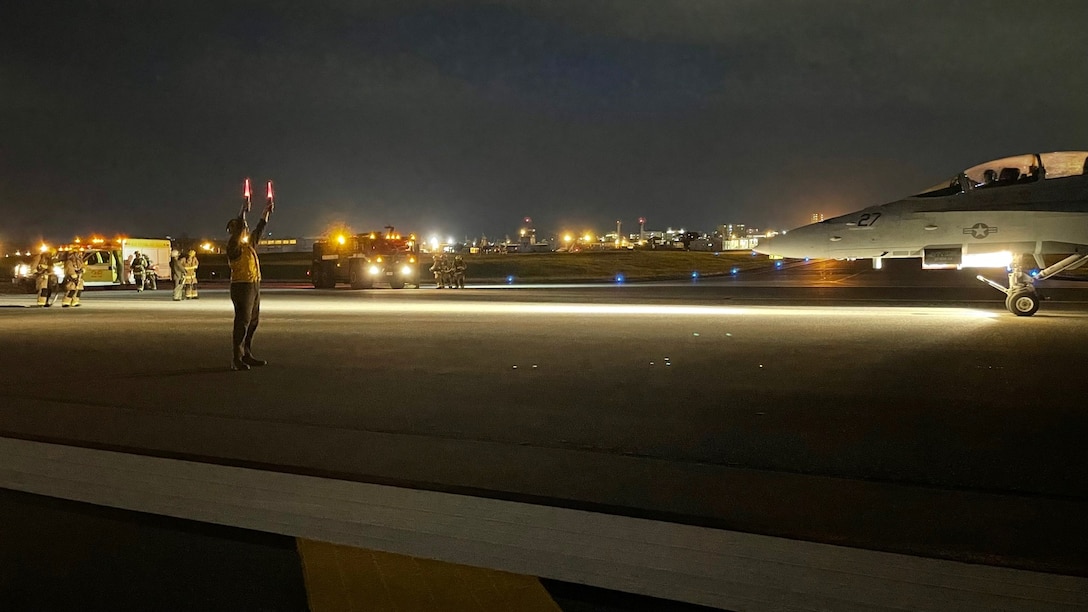Marines from MCAS Futenma Expeditionary Firefighting and Recovery conduct night arrested landing training with F/A-18s from VMFA(AW)-115.
