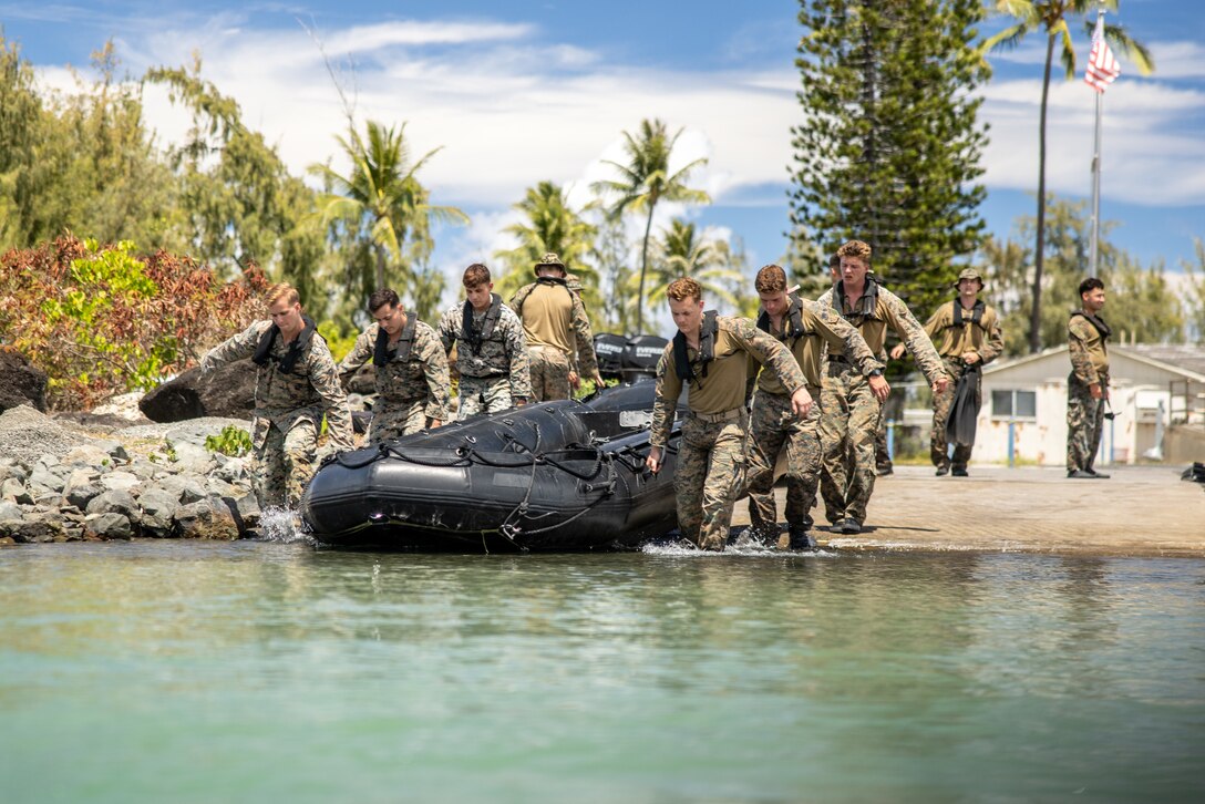 U.S. Marines with 3d Reconnaissance Battalion, 3d Marine Division, carry a combat rubber raiding craft into the water before conducting CRRC operations during Pololu Strike at Marine Corps Base Hawaii, Sept. 6, 2023. Pololu Strike is a 3d MLR exercise consisting of staff education, planning, and battalion-led field training. The training focuses on the education and development of 3d MLR and battalion staffs, deliberate planning repetitions, and execution of training and readiness standards in a field environment.