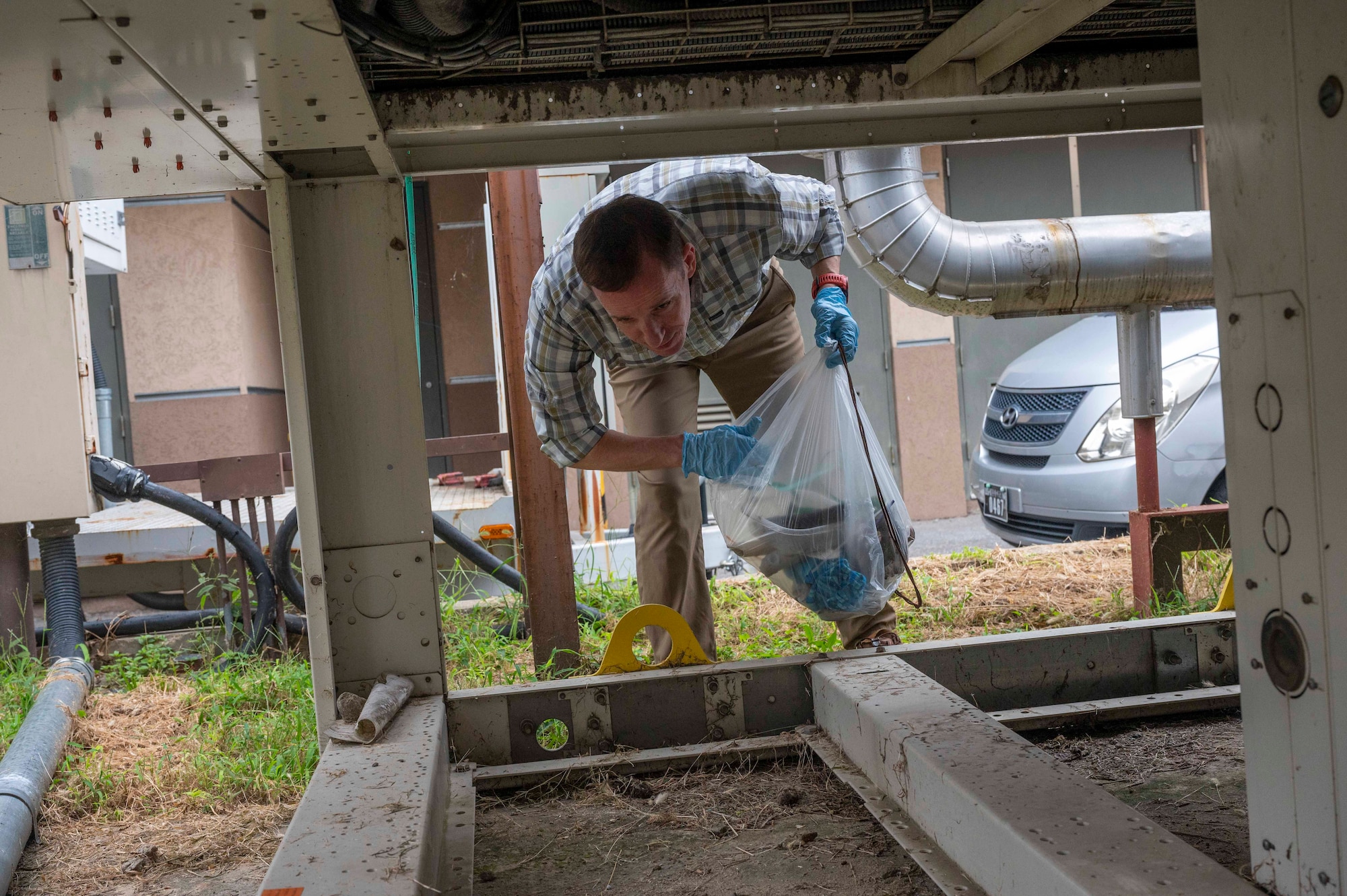 Bradley Carroll, 51st Comptroller Squadron deputy comptroller, picks up trash during a base clean up at Osan Air Base, Republic of Korea, Sept. 13, 2023. Across the base, Airmen and civilians combined efforts to pick up trash, recyclables and debris to maintain environmental standards and invest in the base's infrastructure. (U.S. Air Force photo by Senior Airman Aaron Edwards)