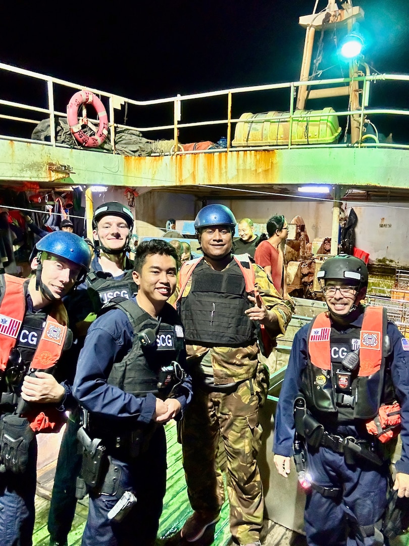 Members of a USCGC Myrtle Hazard (WPC 1139) boarding team and an officer from the Papua New Guinea Defence Force take a moment for a photo on a fisheries boarding on a People’s Republic of China-flagged fishing vessel during a combined patrol on Sept. 1, 2023, in the Coral Sea off Papua New Guinea. The U.S. Coast Guard was in Papua New Guinea at the invitation of the PNG government to join their lead in maritime operations to combat illegal fishing and safeguard marine resources following the recent signing and ratification of a bilateral maritime law enforcement agreement between the United States and Papua New Guinea. (U.S. Coast Guard photo by Chief Warrant Officer Sara Muir)