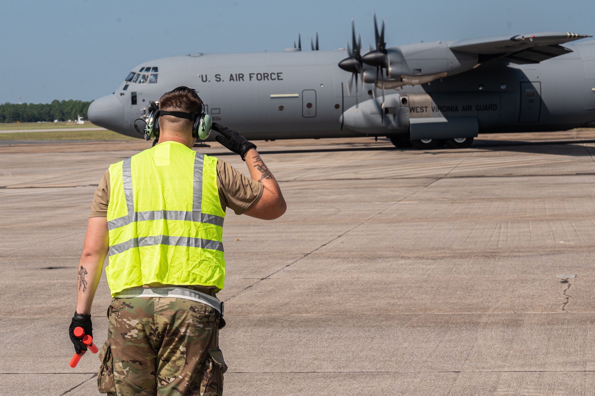 An airman assigned to the 130th Airlift Wing salutes a C-130J-30 before taking off during the unit's Fly Away Readiness Exercise Validation (FLARE-V) held at the Gulfport Combat Readiness Training Center (CRTC), Gulfport, Miss Sept. 8, 2023. FLARE-V is a Commander Directed Readiness Exercise designed to inform commanders of their units' ability to Generate and employ-sustain combat capability across the spectrum of warfare. (U.S. Air National Guard photo by 2nd Lt. De-Juan Haley)