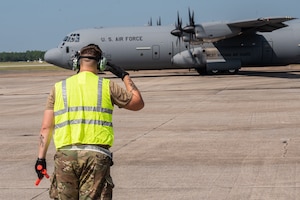 An airman assigned to the 130th Airlift Wing salutes a C-130J-30 before taking off during the unit's Fly Away Readiness Exercise Validation (FLARE-V) held at the Gulfport Combat Readiness Training Center (CRTC), Gulfport, Miss Sept. 8, 2023. FLARE-V is a Commander Directed Readiness Exercise designed to inform commanders of their units' ability to Generate and employ-sustain combat capability across the spectrum of warfare. (U.S. Air National Guard photo by 2nd Lt. De-Juan Haley)