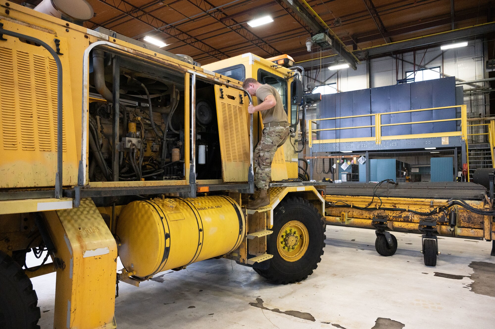 Staff Sgt. Dustin Downen, 436th Logistics Readiness Squadron base maintenance shop supervisor, climbs down from a snow sweeper at Dover Air Force Base, Delaware, Aug. 30, 2023. During the 436th LRS vehicle maintenance shop’s summer rebuild, each vehicle underwent an extensive, multipoint inspection that determined which repairs were required to ensure the vehicles are prepared for the winter season. (U.S. Air Force photo by Airman 1st Class Dieondiere Jefferies)