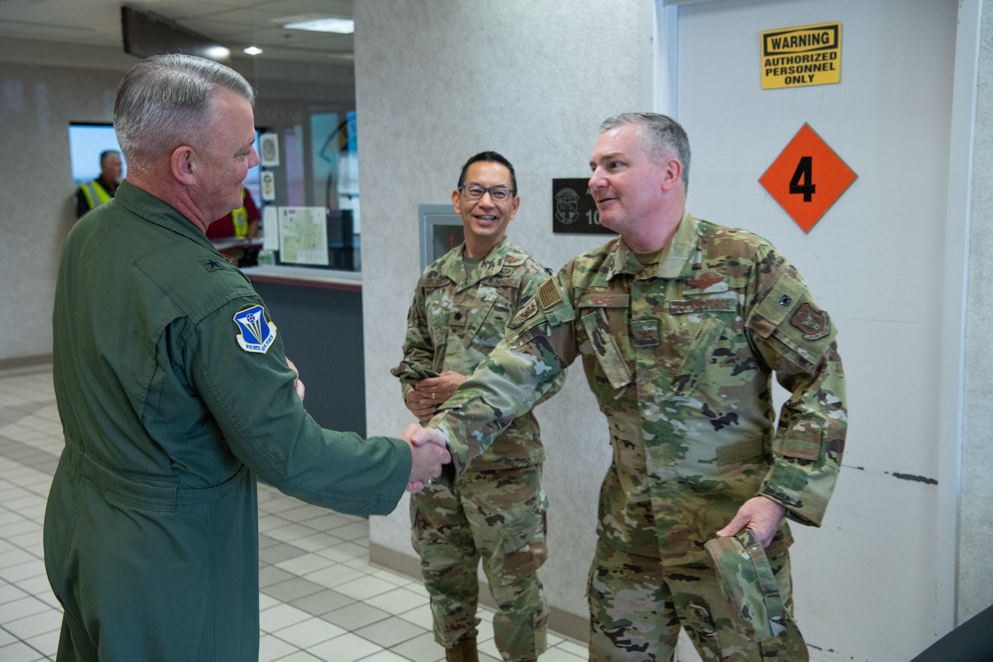 Brig. Gen. Derin Durham, 4th AF commander, is greeted by Col. Terry McGee, 349 AMW commander at the Travis Mission Planning Center.