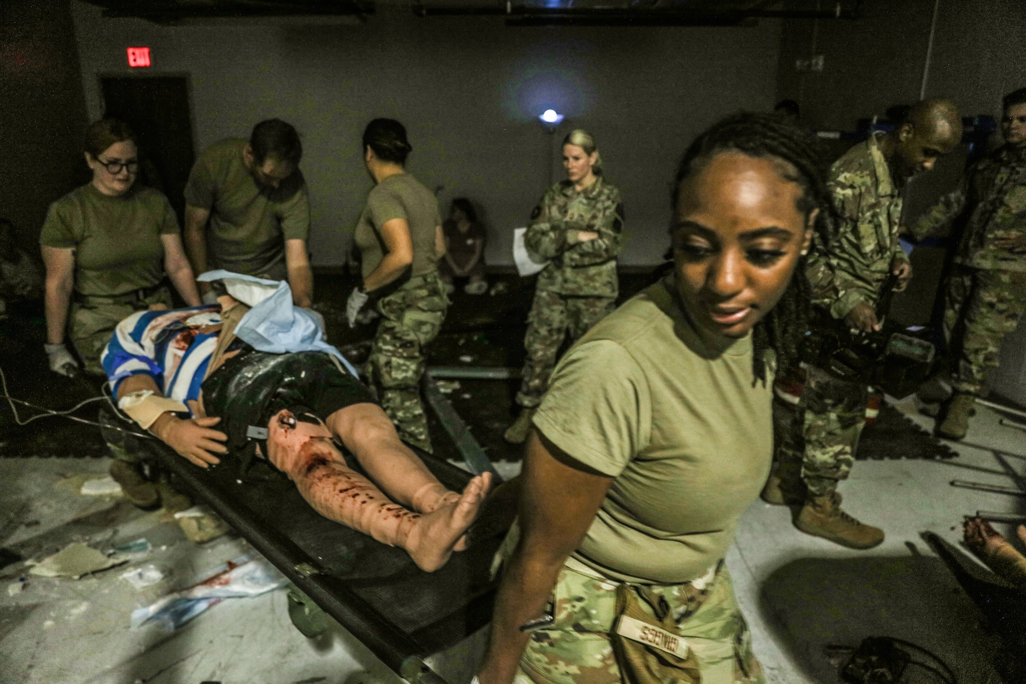 Members of the 445th Aeromedical Staging Squadron carry a training mannequin during a simulated mass casualty exercise Aug. 5, 2023, at Wright-Patterson Air Force Base, Ohio. The exercise simulated casualties from gunfire and bombs while inside a structure with collapsed debris. Exercise role players and mannequins were rescued by the participants and treated during the training. (U.S. Air Force photo/Master Sgt. Patrick O’Reilly)