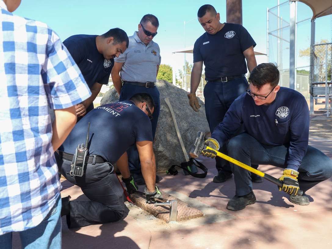 U.S. Marine Corps Air Station (MCAS) Yuma fire department personnel help unseal a time capsule at Thomas Meyer Memorial Field at MCAS Yuma, Arizona, Oct. 31, 2022. The field was dedicated to Thomas Meyer at a formal ceremony, Oct. 31, 1997, after he was struck and killed by a motor vehicle while riding a bicycle, Nov. 1, 1996. (U.S. Marine Corps photo by Lance Cpl. Jon C. Stone)