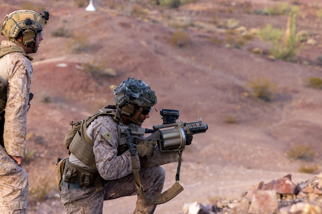 U.S. Marine Corps Lance Cpl. Roman Elizondo, a grenadier assigned to Alpha Company, Battalion Landing Team 1/5, 15th Marine Expeditionary Unit, fires an M32 grenade launcher during a live-fire range as part of Realistic Urban Training exercise at Yuma Proving Grounds, Arizona, Aug. 18, 2023. RUT is a land-based predeployment exercise which enhances the integration and collective capability of the Marine Air-Ground Task Force while providing the 15th MEU an opportunity to train and execute operations in an urban environment. (U.S. Marine Corps photo by Lance Cpl. Kahle)