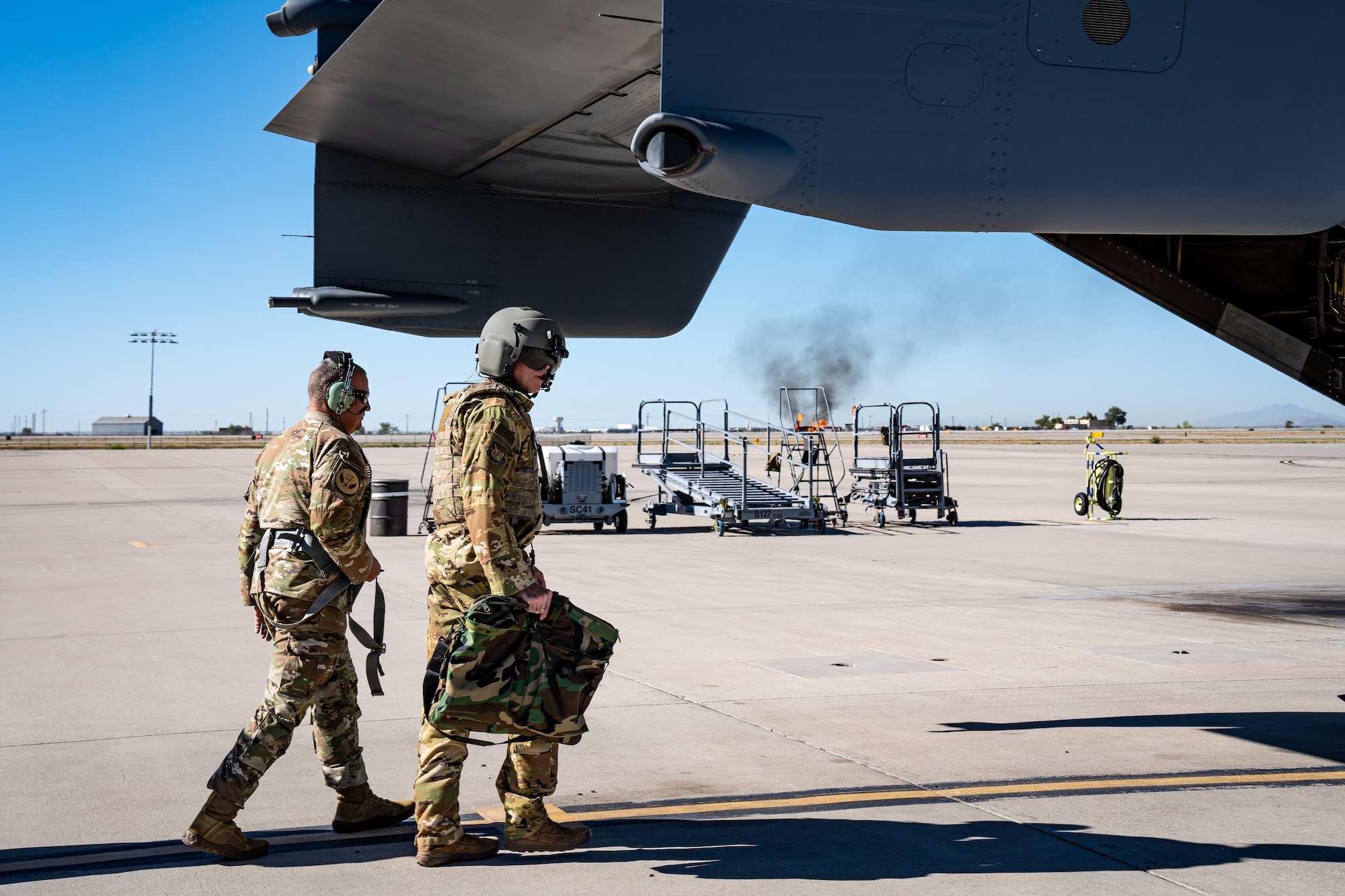 Men walk towards aircraft.