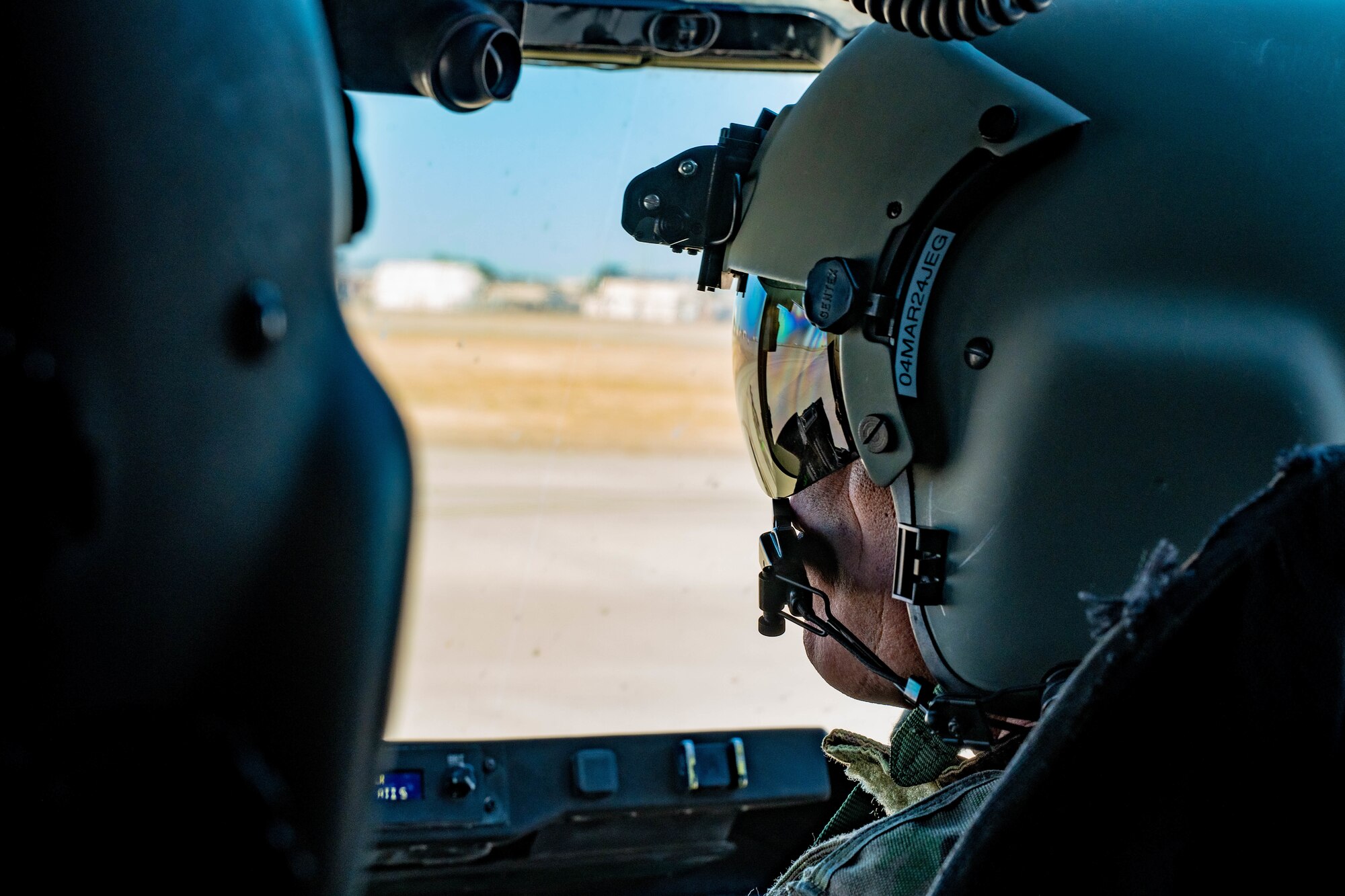 Man sits in pilot seat.