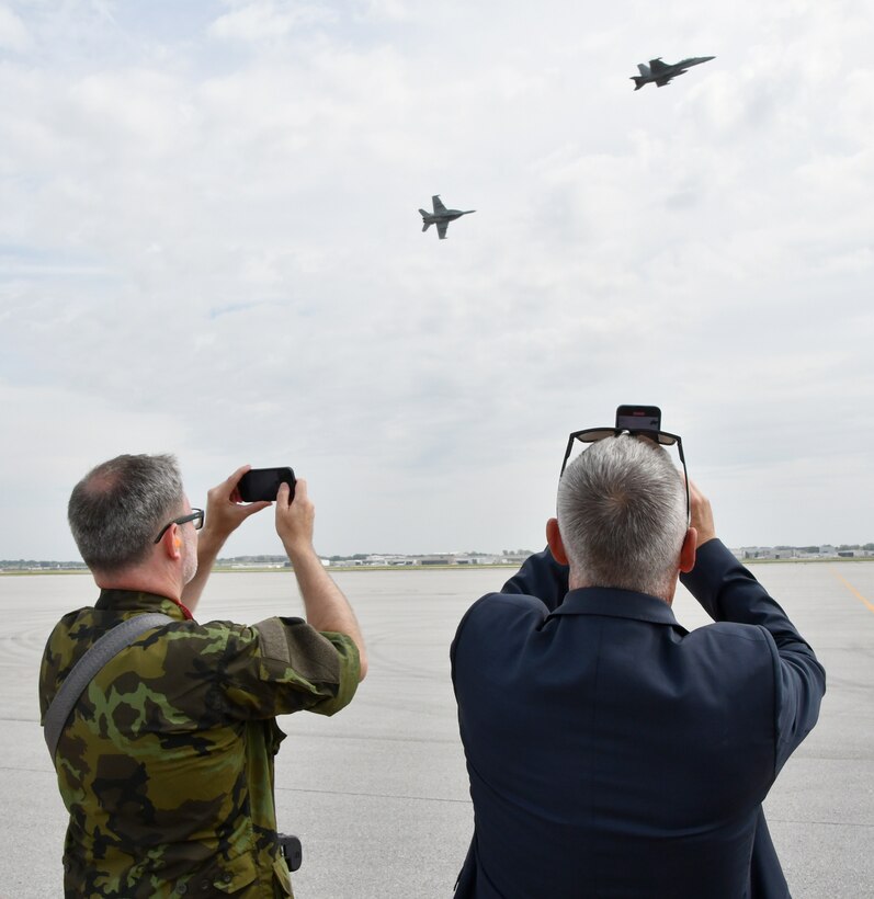 Members of the Czech delegation take photos of a pair of U.S. Navy EA-18 Growlers during an aerial demonstration, Aug. 26, 2023, during the Guardians of Freedom Airshow in Lincoln, Nebraska.