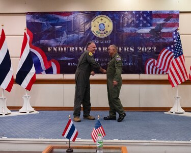 U.S. Air Force Brig. Gen. Gent Welsh, Washington Air National Guard commander, and Royal Thai Air Force Group Captain Nat Kamintra, exercise director, shake hands after formally opening Enduring Partners 2023 , Korat Air Base, Kingdom of Thailand, September 11, 2023. The exercise is a joint exercise between the Kingdom of Thailand, the Washington and Oregon Air National Guard, the units will be practicing aerial refueling and fighter tactics. The Washington National Guard has a long-standing State Partnership with the Kingdom of Thailand.