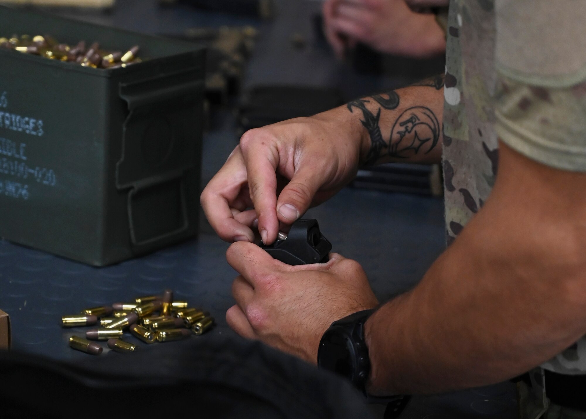 U.S. Air Force Senior Airman Christian Cornejo, tactical air control party Airman with the 5th Air Support Operations Squadron, loads a magazine with 9mm rounds during a pistol accuracy course at Joint Base Lewis-McChord, Washington, Sept. 8, 2023. The 1st Special Forces Group (Airborne) integrated with the 5th ASOS for a pistol accuracy course where they shot over 18,000 rounds throughout the three-day course. (U.S. Air Force photo by Senior Airman Callie Norton)