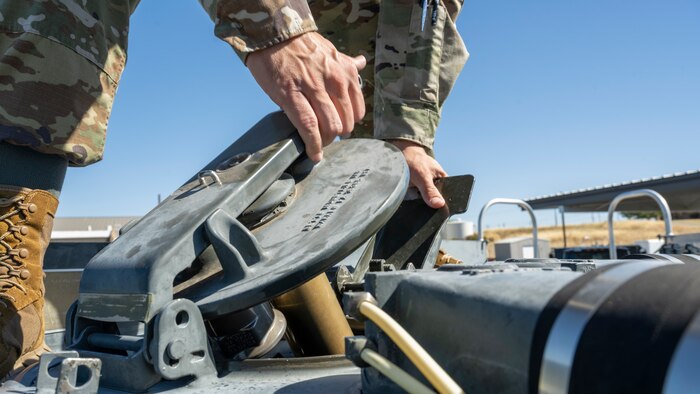 Tech. Sgt. Chance Scharer, 9th Logistics Readiness Squadron petroleum, oil, and lubricants (POL) NCO in charge of fuels, environmental and safety, opens a hatch to inspect fuel July 12, 2023, at Beale Air Force Base, California.
