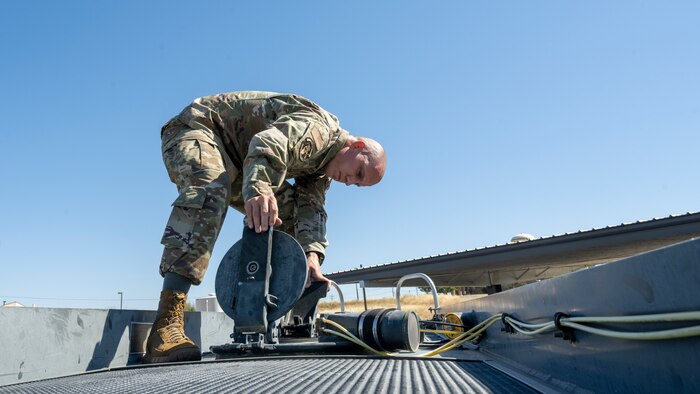 Tech. Sgt. Chance Scharer, 9th Logistics Readiness Squadron petroleum, oil, and lubricants (POL) NCO in charge of fuels, environmental and safety, inspects fuel July 12, 2023, at Beale Air Force Base, California.