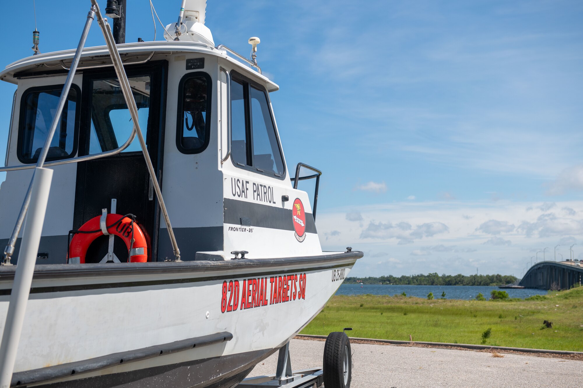 Small boat is parked in lot facing Pearl Bayou.