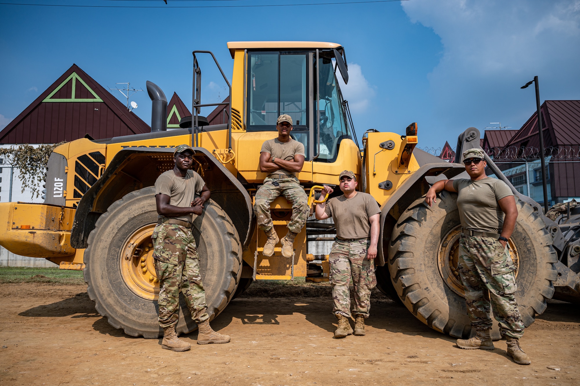 U.S. Air Force Airmen from the 51st Civil Engineer Squadron pavements and construction equipment flight, pose for a group photo at Osan Air Base, Republic of Korea, Sept. 11, 2023. The nickname "Dirt Boyz" reflects their hands-on roles in maintaining the base and employing heavy construction machinery to support Osan's operational readiness. Their primary responsibility is to ensure airfield maintenance, enabling the 51st Fighter Wing to deploy aircraft swiftly and efficiently for the defense of the ROK. (U.S. Air Force photo by Staff Sgt. Thomas Sjoberg)