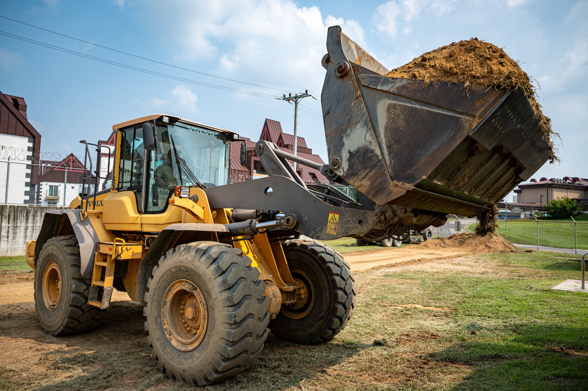 U.S. Air Force Senior Airman Fomba Kamara, 51st Civil Engineer Squadron pavements and equipment journeyman, operates a front-end loader at Osan Air Base, Republic of Korea, Sept. 11, 2023. The 51st CES pavements and equipment Airmen play a pivotal role in upholding mission readiness by ensuring the structural integrity of our airfield and various other infrastructures guaranteeing the 51st Fighter Wing is always prepared to defend Osan and the Republic of Korea. (U.S. Air Force photo by Staff Sgt. Thomas Sjoberg)