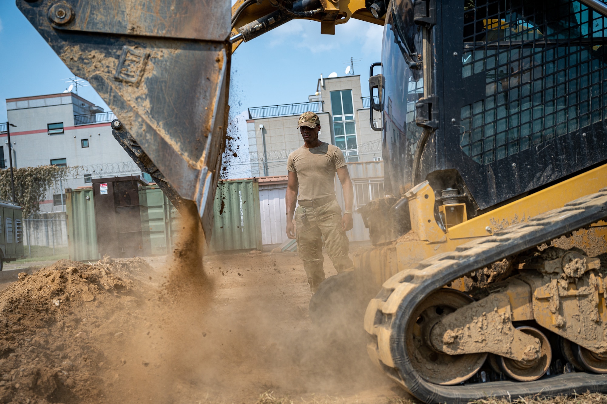U.S. Air Force Senior Airman Abrein Dunn, 51st Civil Engineer Squadron pavements and equipment journeyman, supervises a construction project at Osan Air Base, Republic of Korea, Sept. 11, 2023. The primary duty of the 51st CES pavements and construction equipment flight is to maintain Osan’s airfield, enabling flight operations to continue without delay or interruption due to airfield damage. (U.S. Air Force photo by Staff Sgt. Thomas Sjoberg)