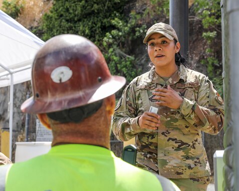 Joint Task Force-Red Hill (JTF-RH) Access Control Point (ACP) team member, U.S. Air National Guard Senior Airman Maritza Garcia, provide assistance to JTF-RH civilian at the Red Hill Bulk Fuel Storage Facility (RHBFSF) ACP, Halawa, Hawaii, Sept. 12, 2023.