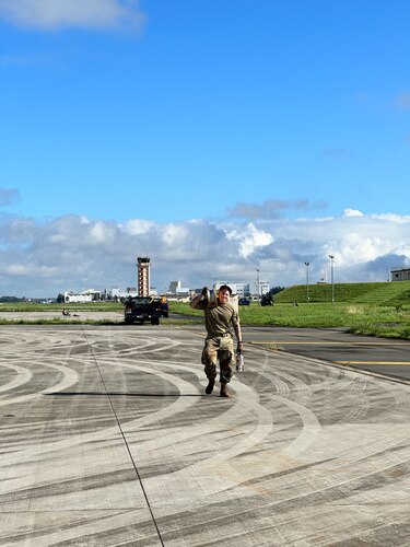 U.S. Air Force Staff Sgt. David Tran, 374th Communications Squadron cable and antenna supervisor, carries a roller of cables at Yokota Air Base, Japan, Aug. 24, 2023. The 374th Communications Squadron assisted YokoWERX with installing cables to fix the south runway overrun control lights. (Courtesy Photo)